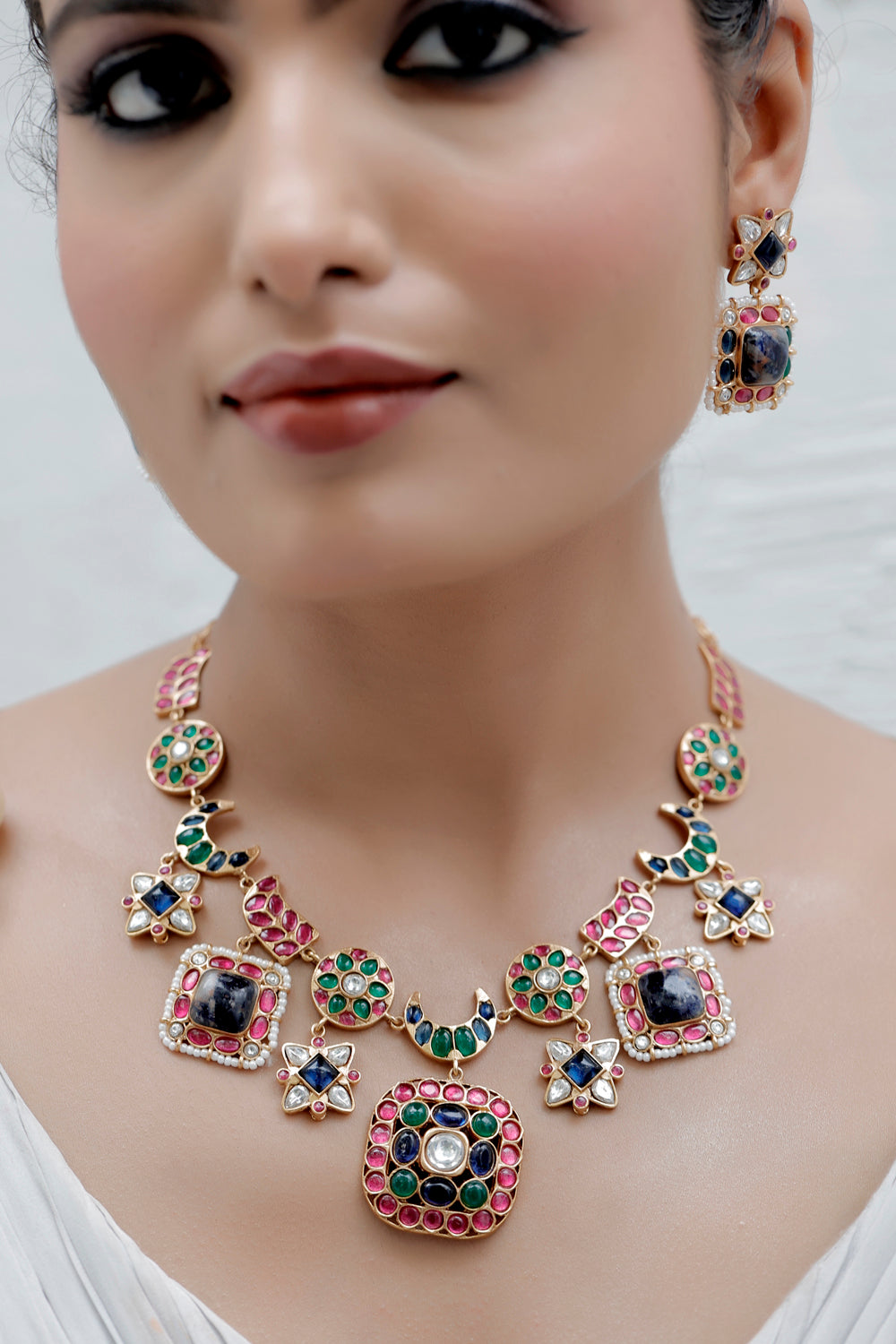 semi precious lapis lazuli with green and pota ruby kundans in matte gold polish unique middle length necklace with drop earrings