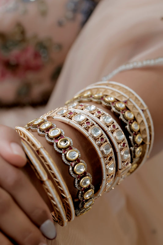 stack of kundan bangles bordered by matte gold 3d bangles
