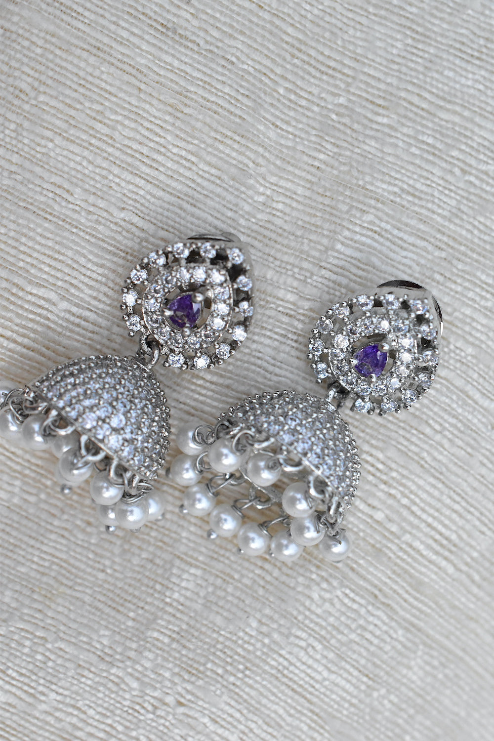 Silver earrings with purple gemstones and pearl accents