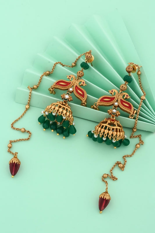 antique gold with meenakari and peacock design and jhumka earrings with green stone danglers
